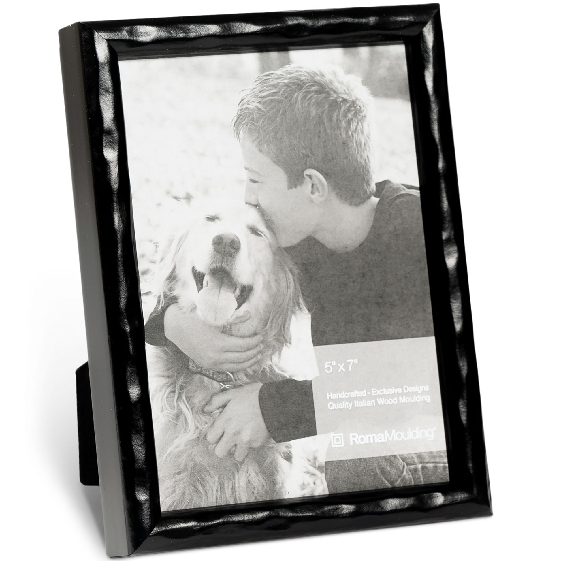Black-framed photo shows a boy kissing a smiling dog. The emotional scene conveys warmth and affection. The frame is labeled "5x7" by Roma Moulding.