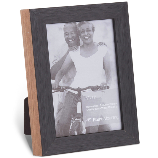 A wooden photo frame with a dark border displays a smiling couple riding a bicycle together. The photo is black and white, conveying joy and togetherness.