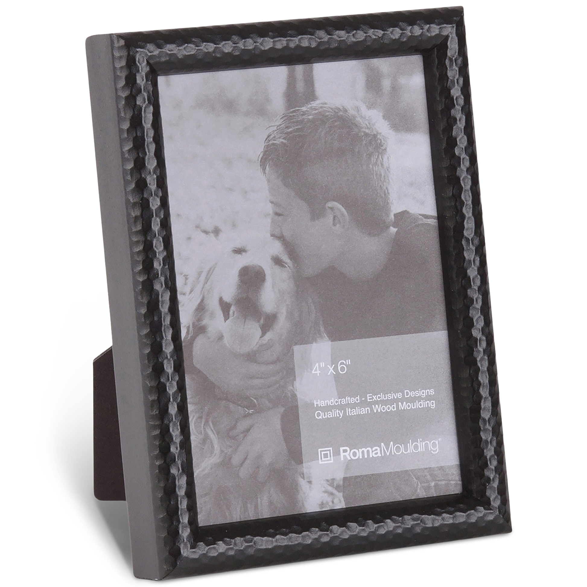 Black, textured photo frame displaying a grayscale image of a boy affectionately kissing a smiling dog. The mood is heartwarming and tender.