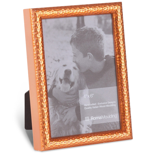 A textured copper frame encases a black-and-white photo of a smiling boy hugging a panting dog. The scene exudes warmth and affection.