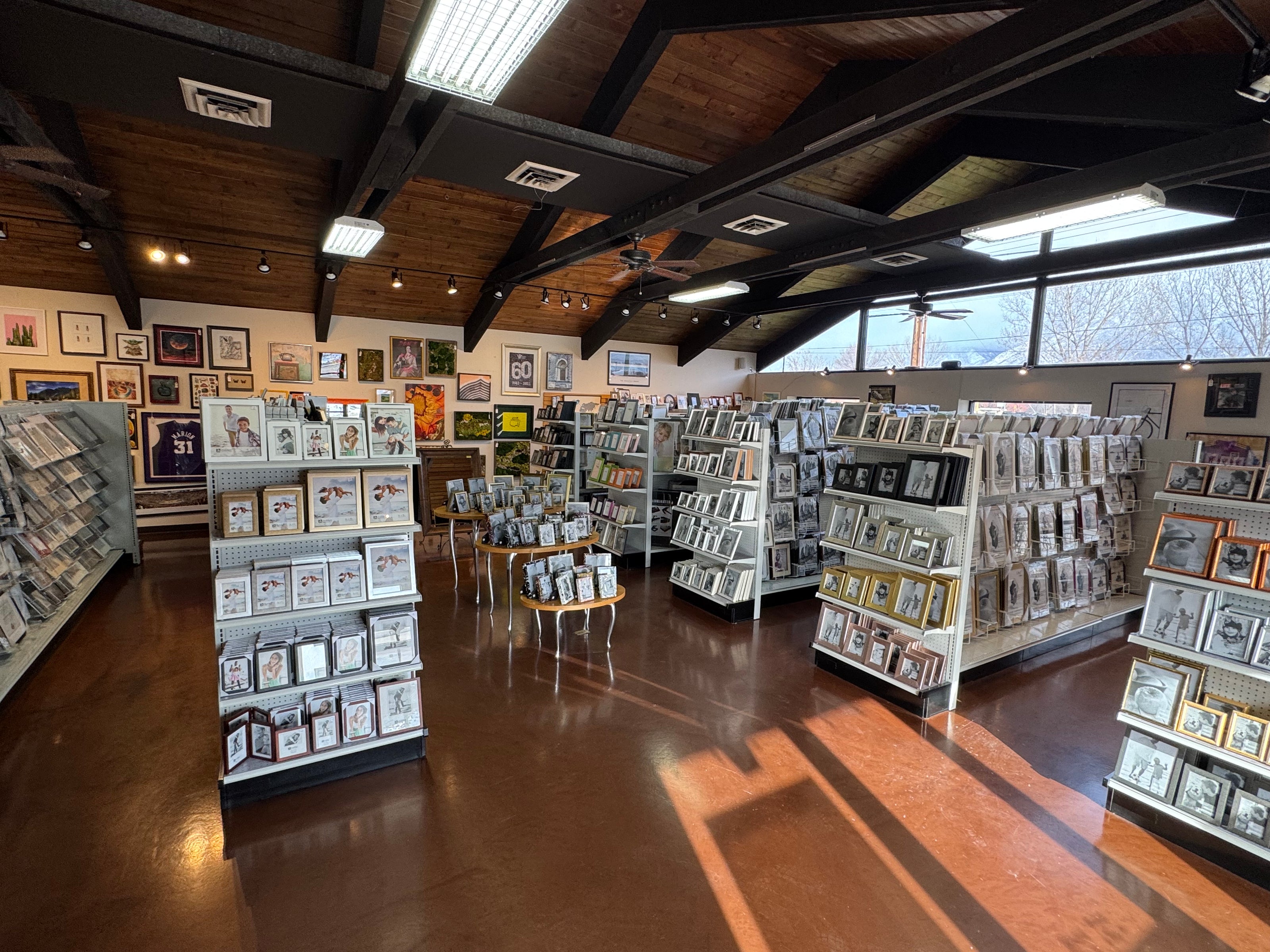 Interior of a store with shelves displaying photo frames and other products.