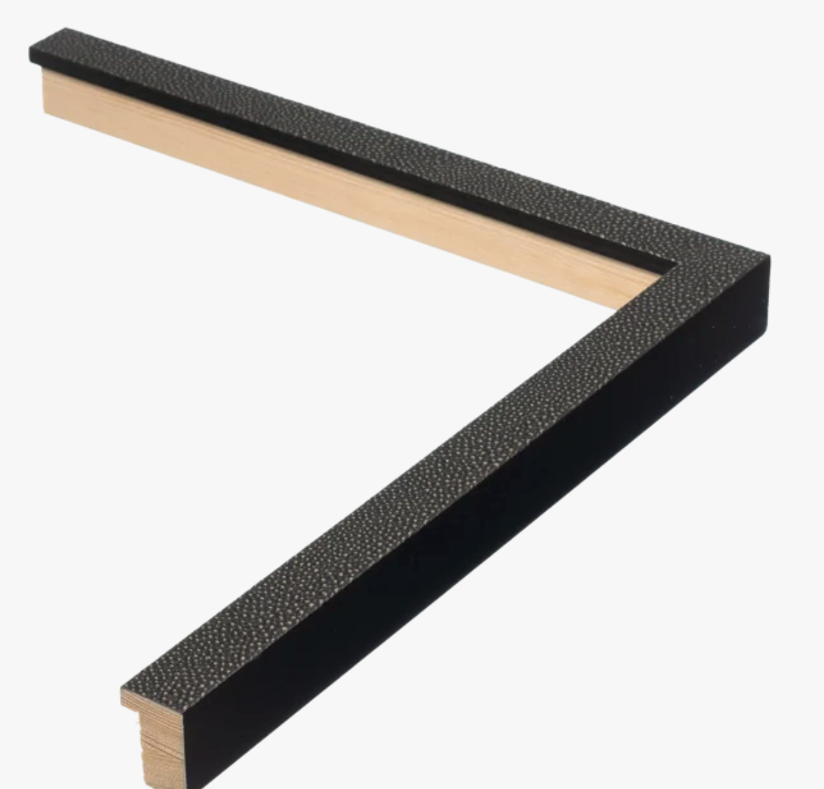 Close-up of a textured black frame corner on a white background. The frame has a slight sheen with a wooden inner edge, conveying a sleek, modern style.