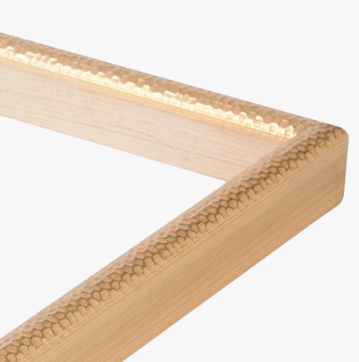 Close-up of a textured black metal picture frame corner with an inner wood accent. The frame has a modern, sleek appearance on a plain white background.