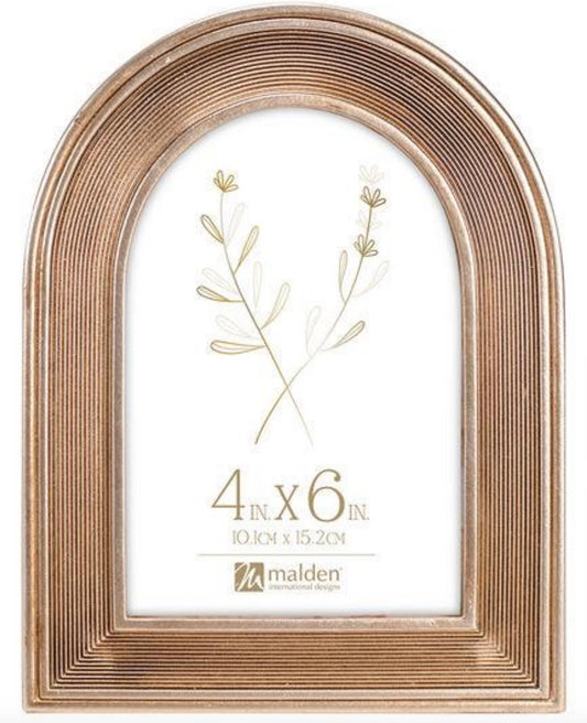 Gold arched picture frame with a plant design and size label on a white background