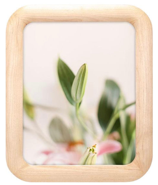 Small wooden photo frame with a blurred floral background