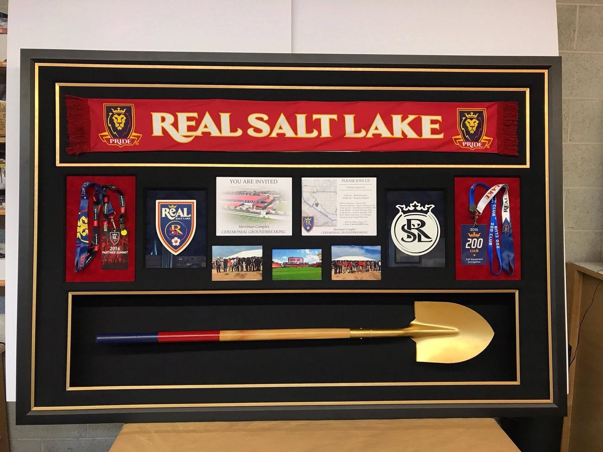 A framed image depicting Real Salt Lake with a shovel and assorted objects displayed beside it