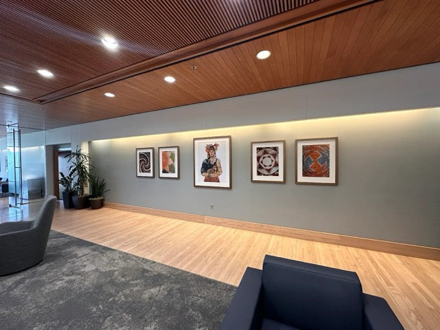 A large office space characterized by wood paneling and framed paintings, contributing to a sophisticated environment.