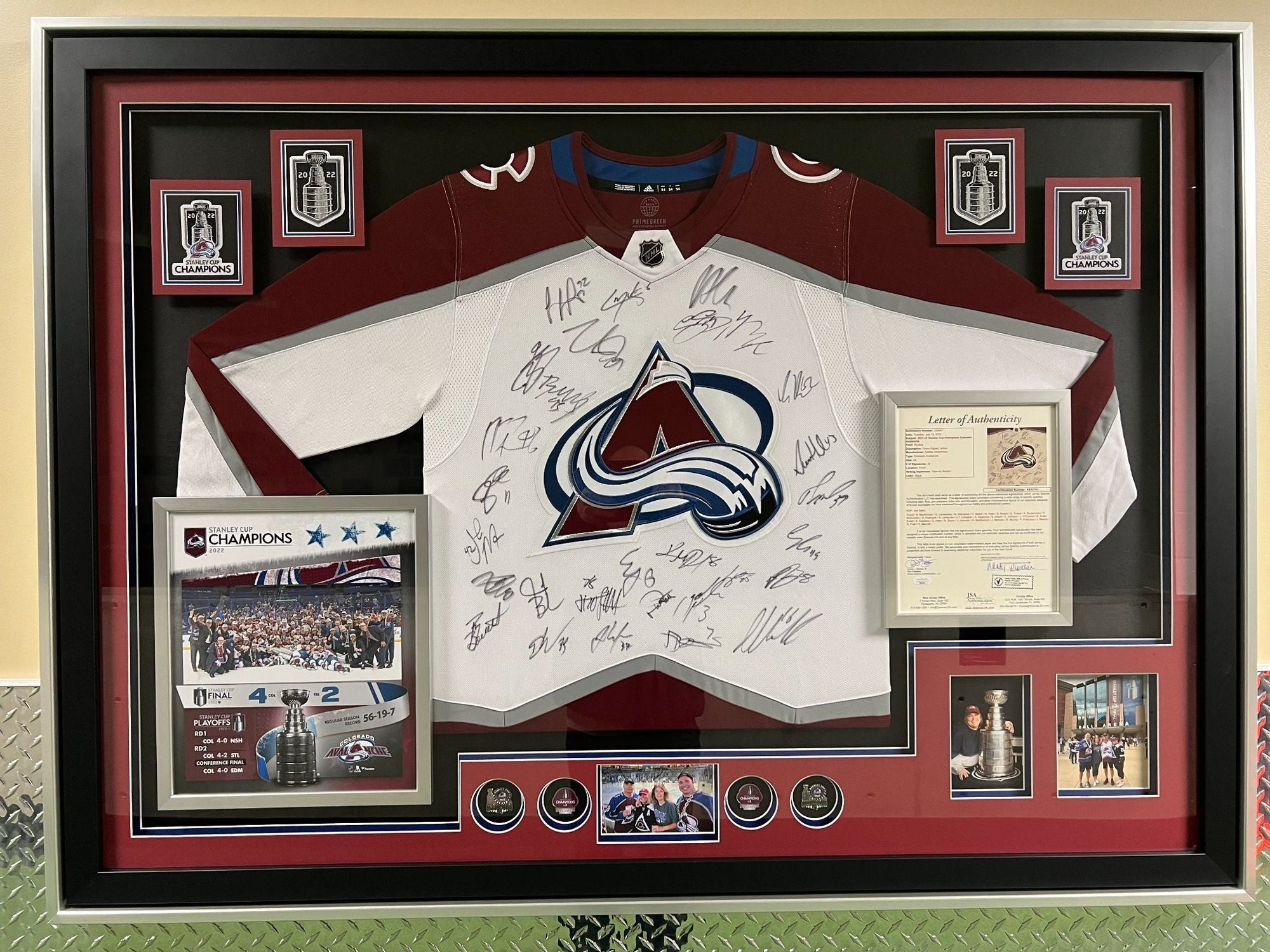 Framed sports jersey with autographs and memorabilia