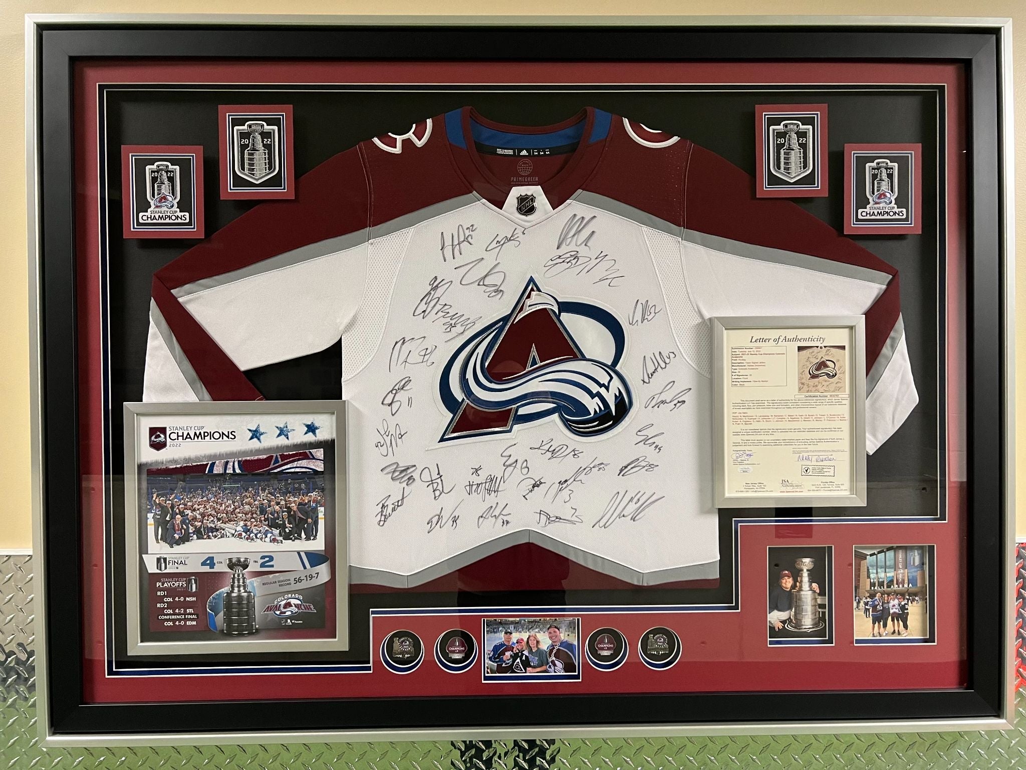 Framed sports jersey with autographs and memorabilia