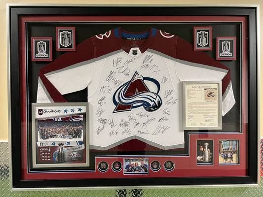 Framed sports jersey with autographs and memorabilia