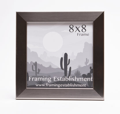 A black 8x8 inch picture frame with a desert scene insert featuring cacti and a sun. Text reads "Framing Establishment" and website below. Clean and minimalistic design.