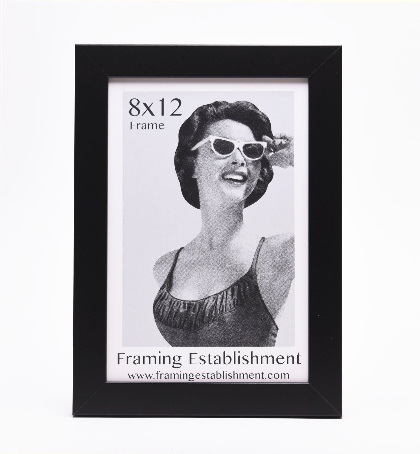 Black picture frame showcasing an 8x12 vintage-style image of a smiling woman in sunglasses and a swimsuit. Text reads "Framing Establishment."