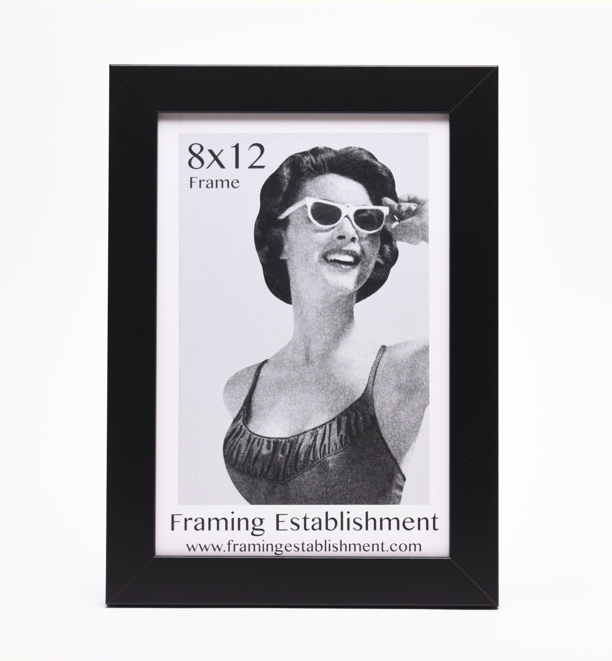 Black picture frame showcasing an 8x12 vintage-style image of a smiling woman in sunglasses and a swimsuit. Text reads "Framing Establishment."