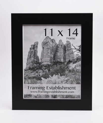 Black frame with a black-and-white photo of towering rock formations. Text reads "11 x 14 Frame" and "Framing Establishment" with a website link.