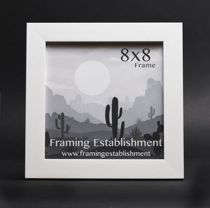 A white satin wall frame with a glass front, labeled '8x10 FRAME' and a picture of a dog inside. The frame has a white backing and a sawtooth hanger.