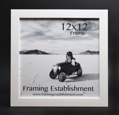 A white satin wall frame with a glass front, labeled '8x10 FRAME' and a picture of a dog inside. The frame has a white backing and a sawtooth hanger.