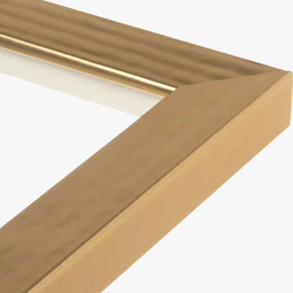 Close-up of a gold picture frame corner with a beveled edge and subtle texture. The frame conveys a modern and elegant tone