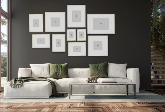Modern living room with a white sofa, green cushions, and framed pictures on the wall.