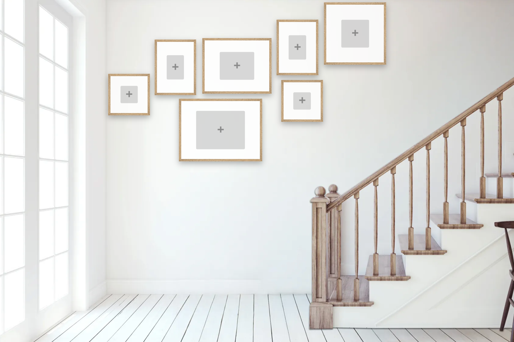 Staircase with wooden railings and white walls with framed pictures.
