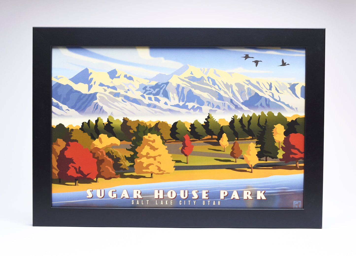 Framed poster of Sugar House Park, Salt Lake City. Features colorful autumn trees, distant snow-capped mountains, and flying birds under a clear sky.